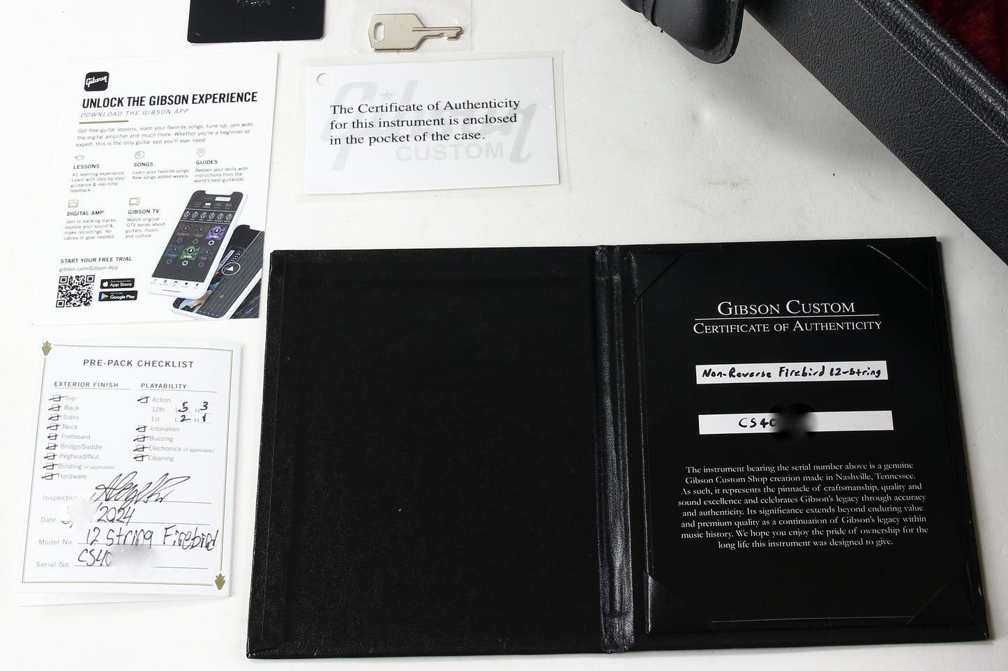 Gibson Custom Certificate of Authenticity in a black case with documentation on a white surface