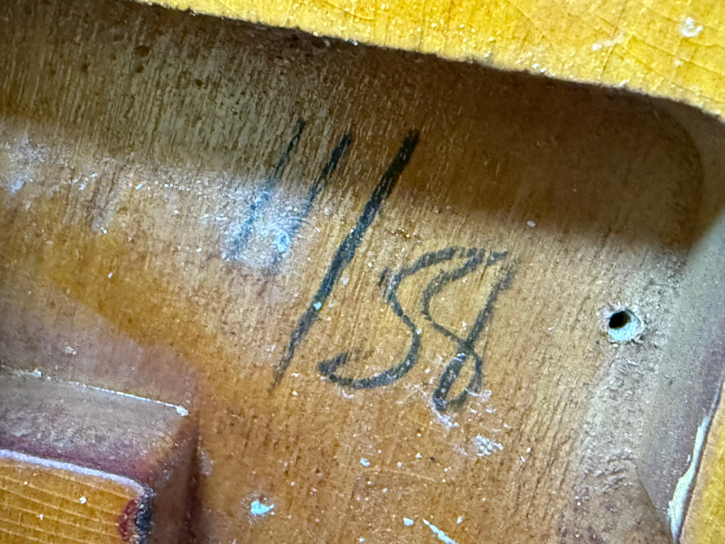 Close-up of 1958 Fender P-Bass with handwritten black numbers '11/58'