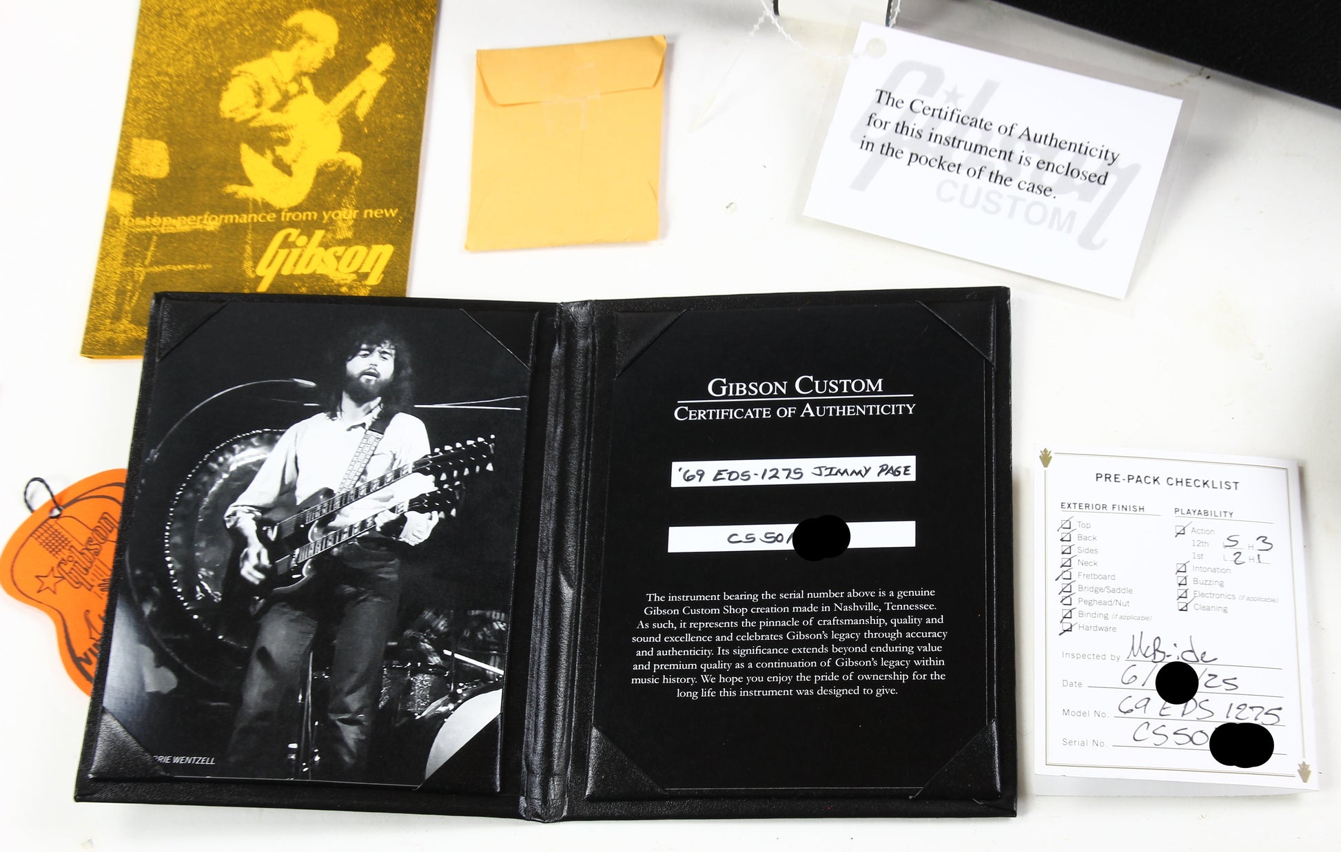Gibson Custom Certificate of Authenticity with promotional material on a white surface