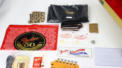 Fender Bill Carson guitar accessories including a strap, leotard, and promotional materials on a white surface.