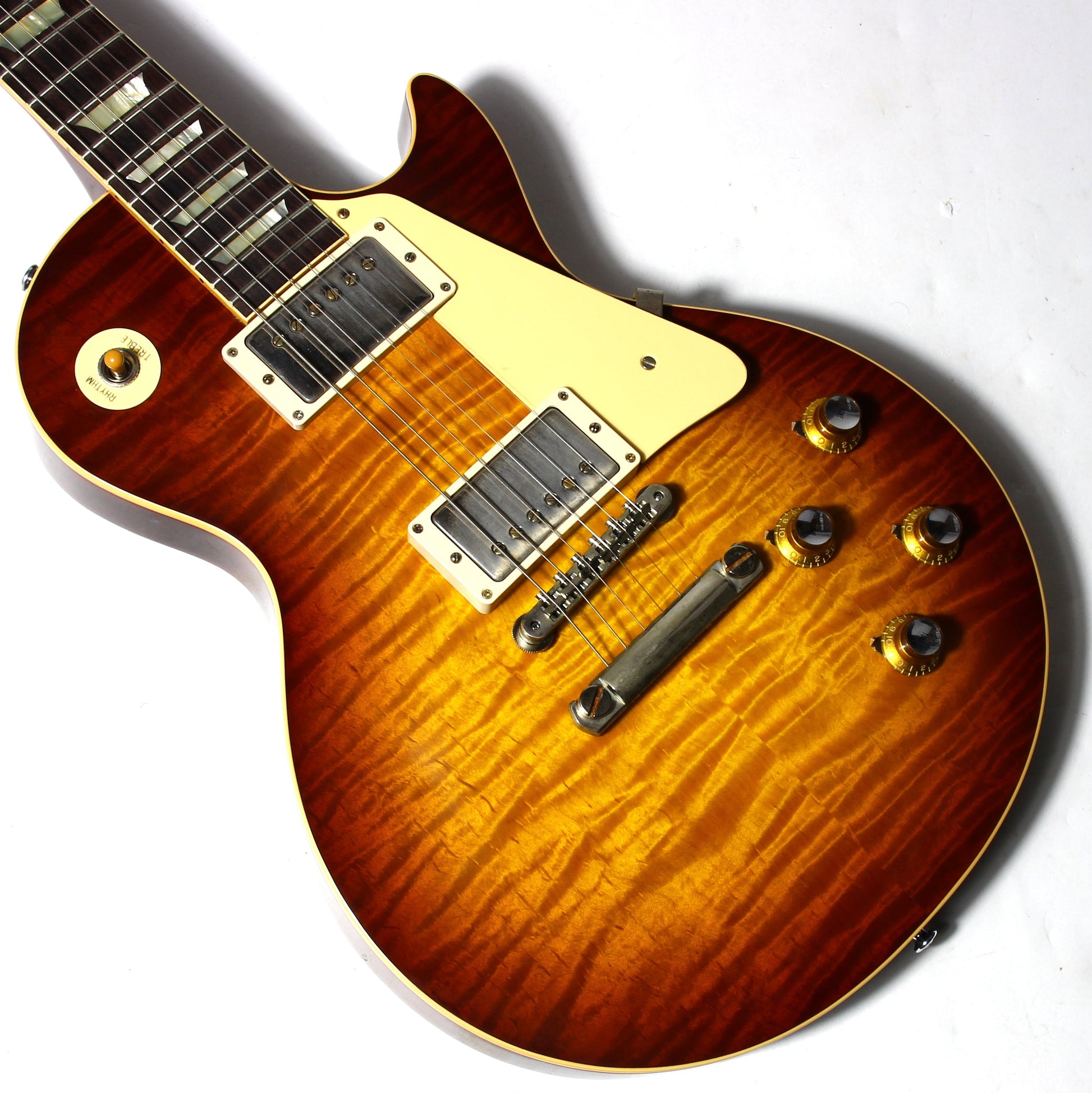 Close-up of a Gibson Les Paul  sunburst electric guitar on a white background