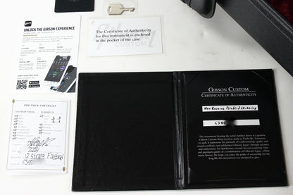 Gibson Custom Certificate of Authenticity in a black case with documentation on a white surface