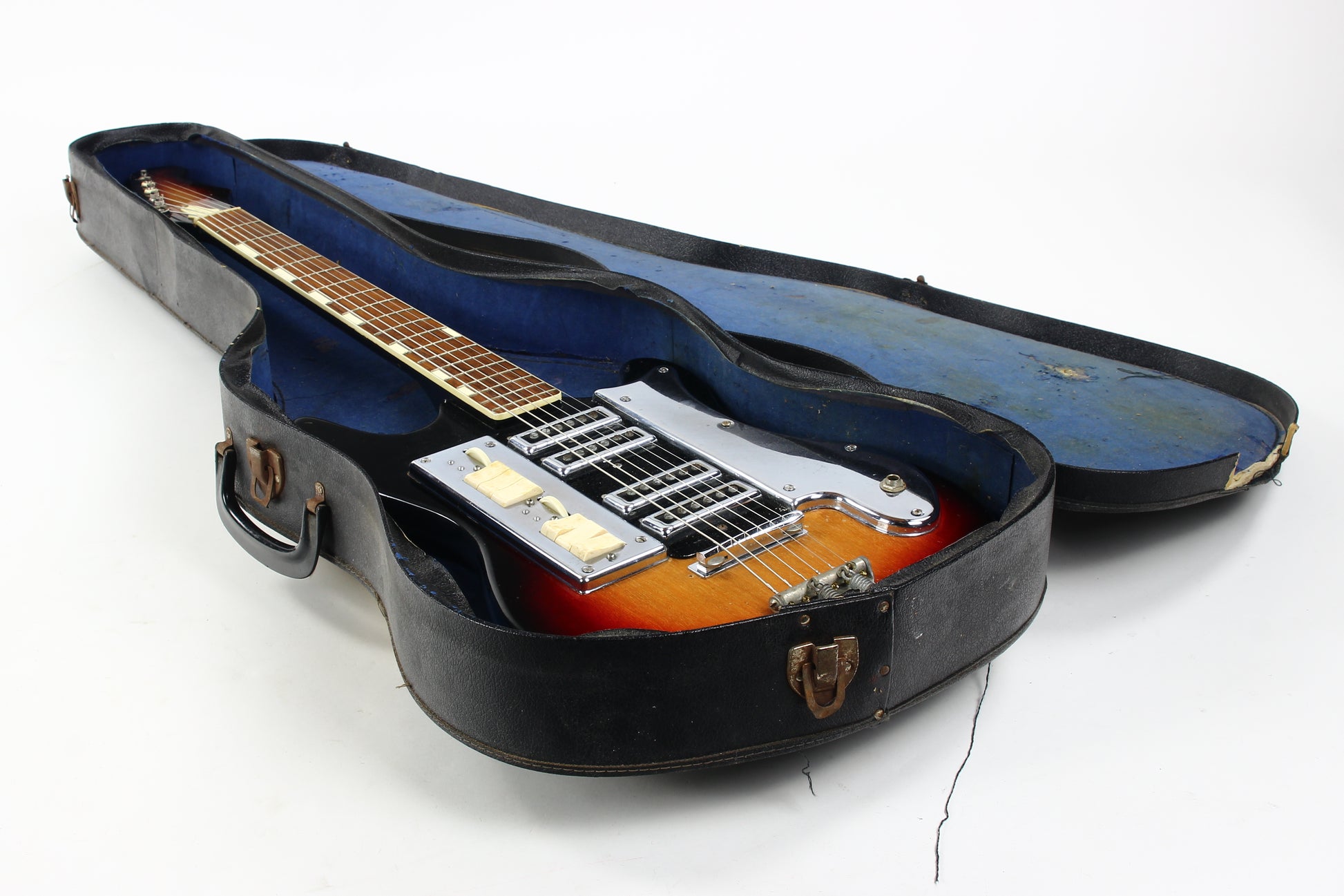 Guitar in a black case on a white background