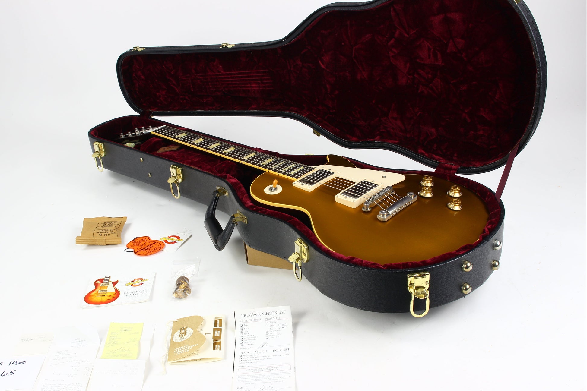 Gibson Les Paul guitar in case with accessories on a white background