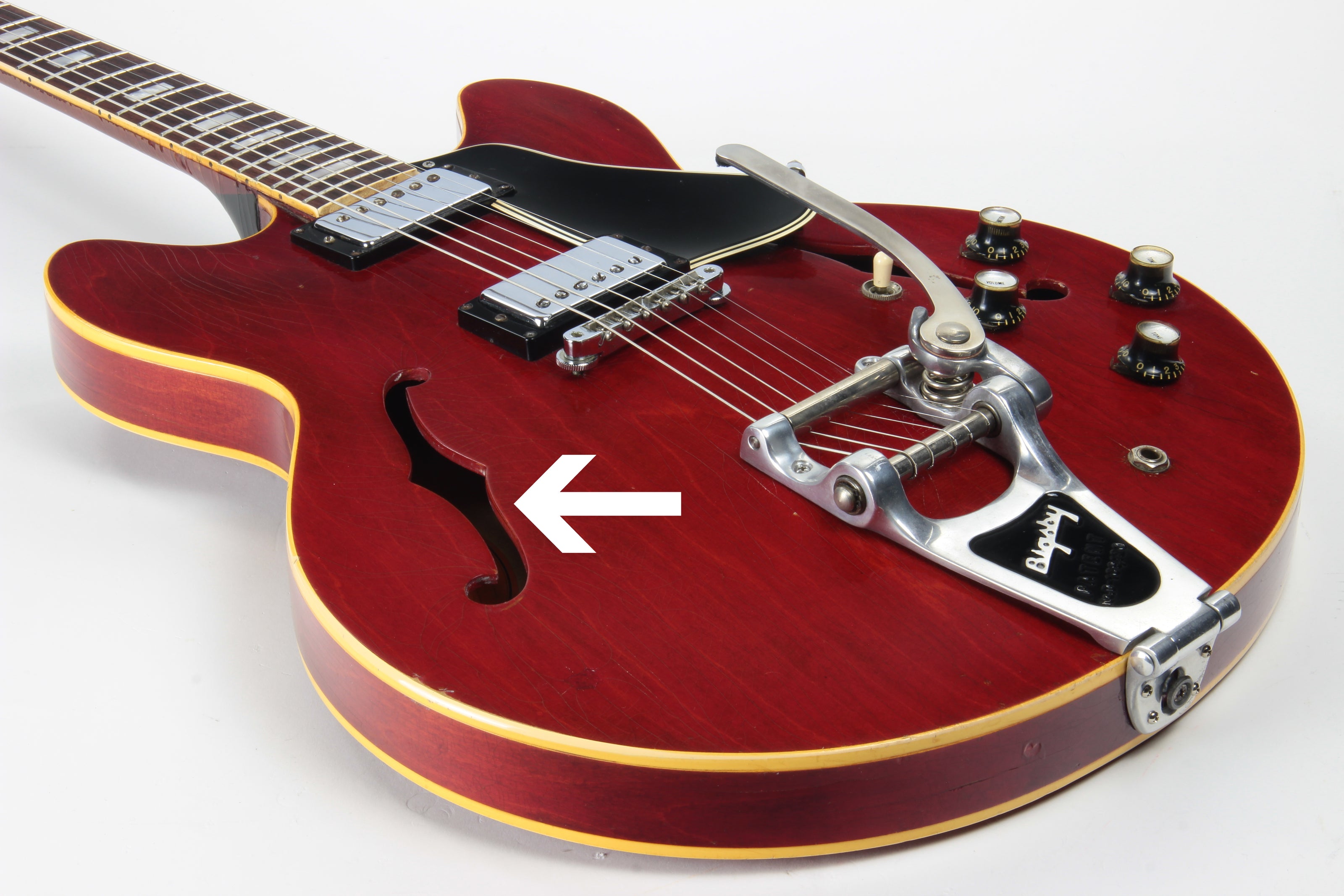 1960's Gibson ES-335 with arrow pointing to bass f-hole